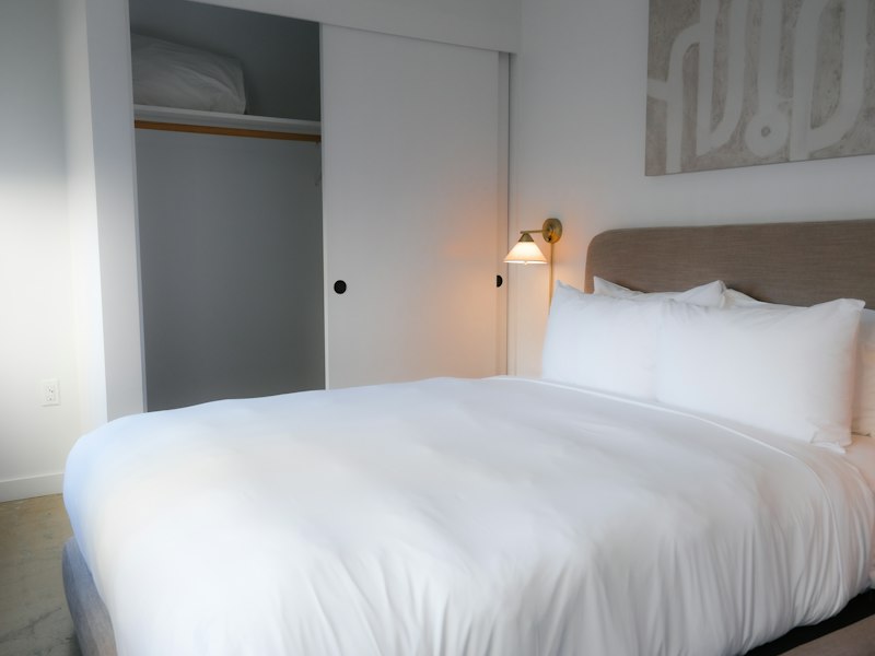 A guest bedroom with a freshly made bed